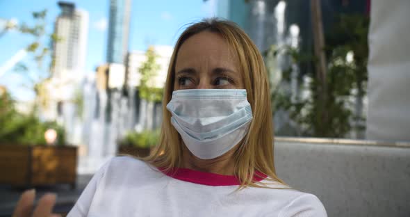 Woman with Mask Doing Refusing Hand Gesture