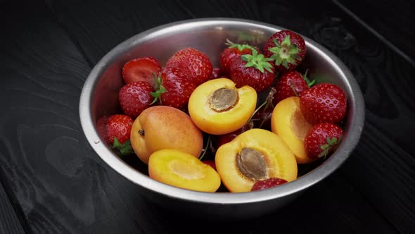 Apricot Strawberries Washed Bowls on Black Wooden Background