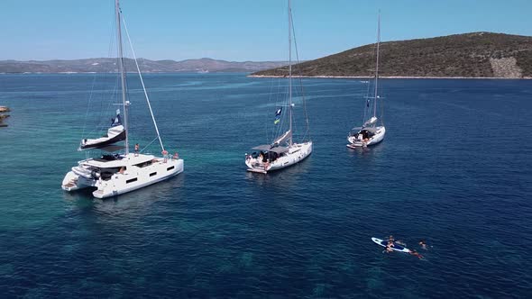 Fly Out From Anchored Sailing Yachts