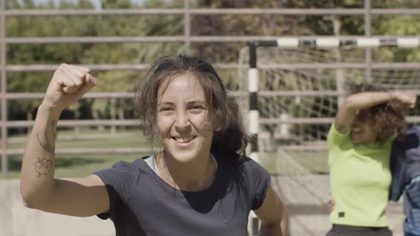 Front View of Happy Female Football Player Rejoicing Victory