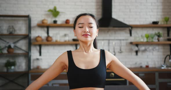 Portrait of Young Asian Woman Doing Yoga Fitnesss Exercise Namaste Asana and Stretching at Home
