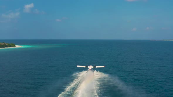 Aerail View on Seaplane Taking Off in a Tropical Island in Maldives