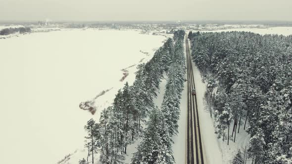 Fabulous Winter Landscape with a Forest and a Country Road Aerial View