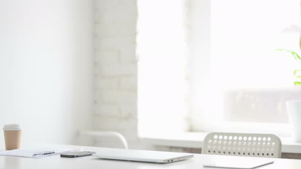 African Woman Coming Back Opening Laptop in Office