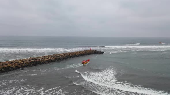 fishing boat going fishing on a day of swells on the coast of chile bucalemu recording of a drone ac