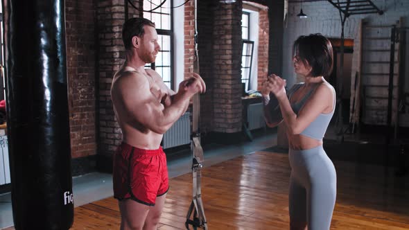 A Couple Training in the Gym  Man and Woman Warming Up Their Hands and Wrists