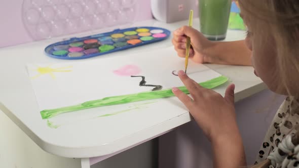 Talented Creative Child Girl Female Artist Draws with Her Hands on Paper Using Fingers Paints Brush