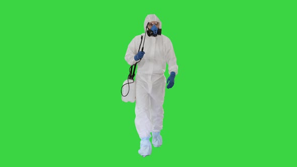 Virologist in Protective Uniform Walking and Disinfecting the Area on a Green Screen, Chroma Key.