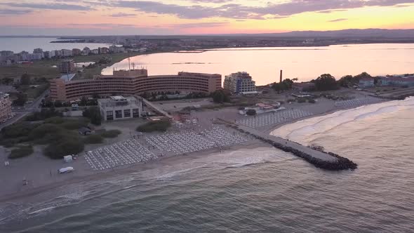 Aerial view of Pomorie city that is located on Black Sea shore at sunset. Top view of sand beaches 