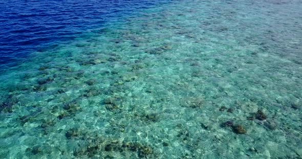 Luxury drone abstract shot of a white paradise beach and aqua blue ocean background in colorful 4K