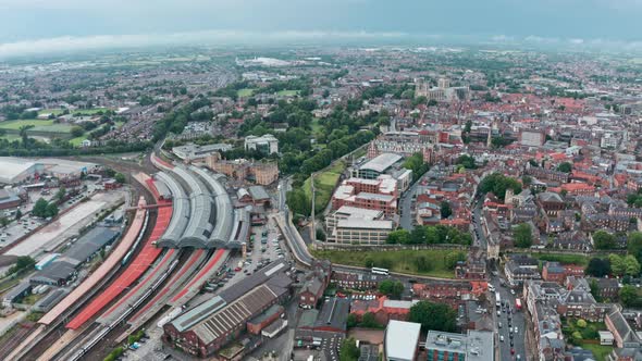 Slider drone shot of train leaving York station UK