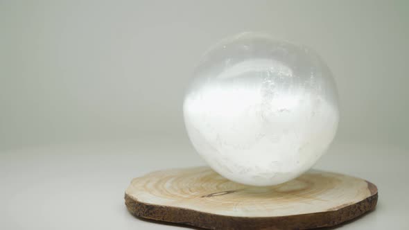 The Bright Round Crystal Ball On  A Wood Craft On Top Of The Turntable - Close Up Shot