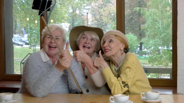 Ladies Taking Selfie at Table