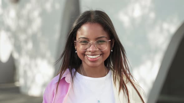 Portrait of Happy Latin African American Female Student Smiling and Looking at Camera with Positive