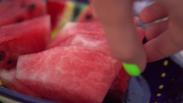 Watermelon Slices on Plate Hands Taking Fruits