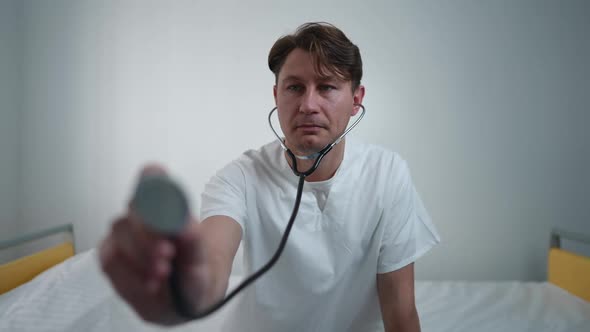 Patient's POV of Focused Professional Doctor Listening Auscultation with Stethoscope Thinking