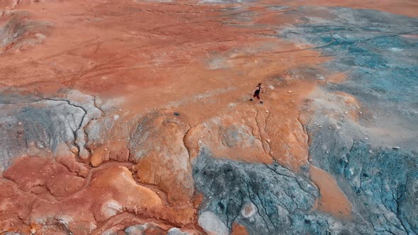 A Man Running on a Clay Mountain - Unusual Landscape