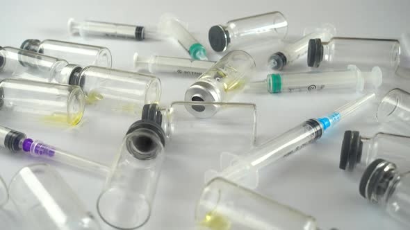 Syringes and ampoules on a white background.