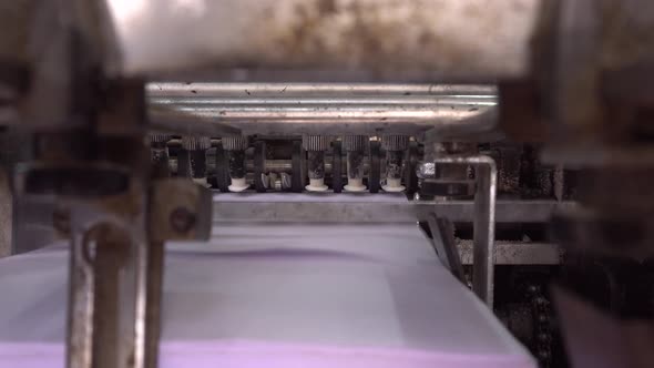 Books are being printed through machines.