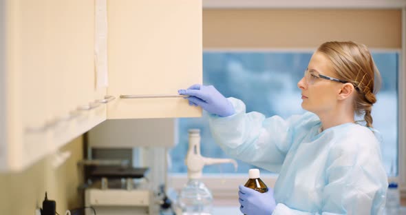 Female Scientist Working In Laboratory alt