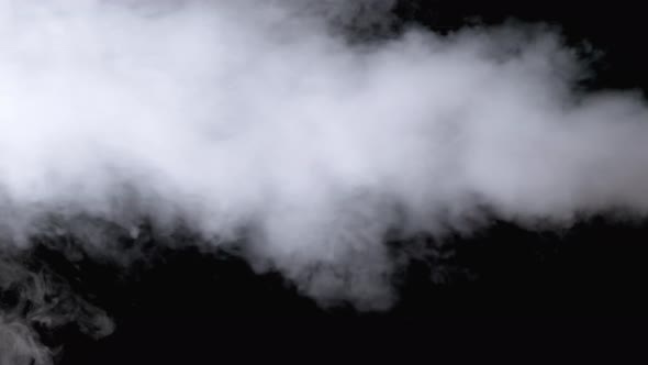 White Water Vapor. Jet of Vapour Steam on Black Background. Slow Motion