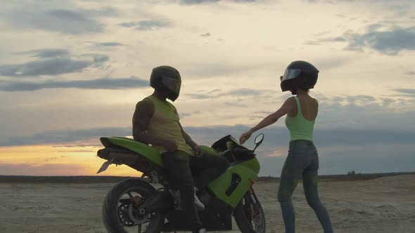 Stylish Couple on Motorbike on Beach