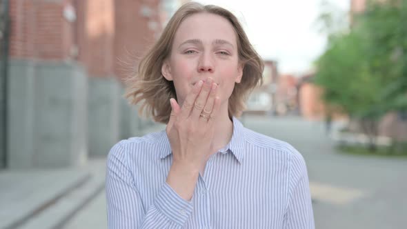 Portrait of Woman Giving Flying Kiss Standing Outdoor