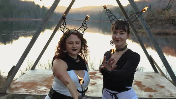 Two Woman Dancing with Flame on Metal Horn