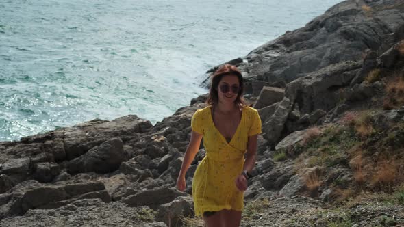 Cheerful Vacationer on Rocky Sea Coast