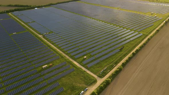 Aerial view of big sustainable electric power plant with rows of solar photovoltaic panels