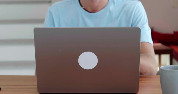 Soft Focus on the Laptop Lid Opened By a Male Freelancer Entrepreneur Businessman Starting His