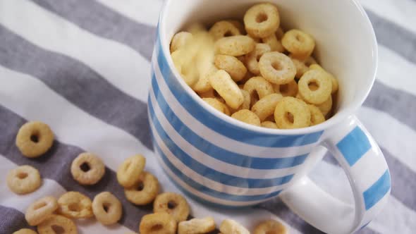 Cereal rings being spilled in a mug 4k