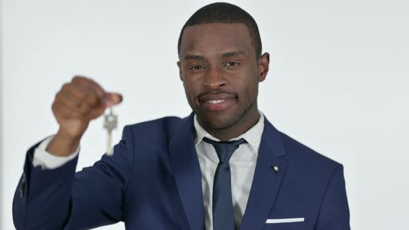 African Businessman Showing Keys of House, White Background