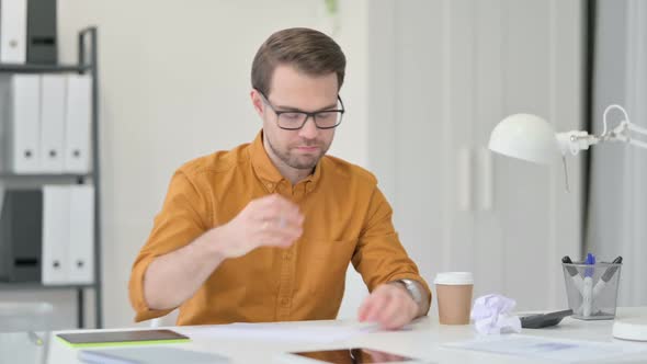 Young Man Failing to Write on Paper