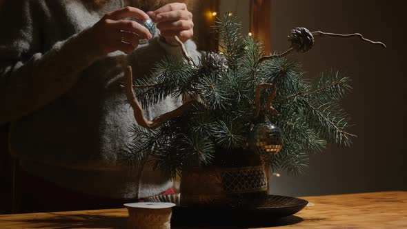 Young Woman Makes Christmas Ikebana