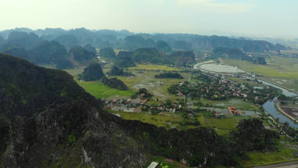 Aerial: North Vietnam karst landscape, drone view of Ninh Binh region, tourist destination