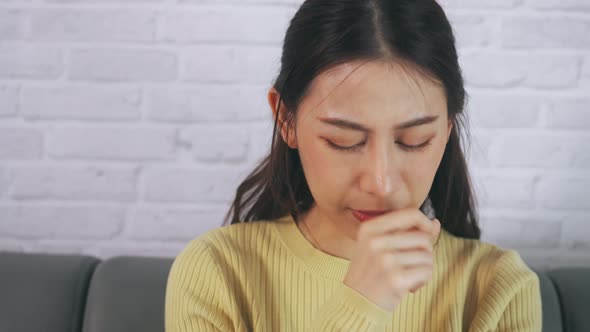 Woman Suffering From Sore Throat and Coughing