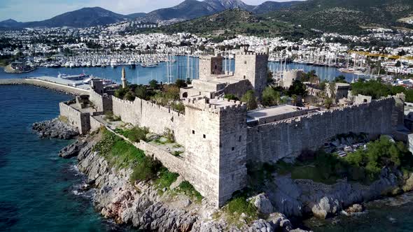 Amazing panoramic view from drone of full of yachts Bodrum harbour and ancient Kalesi castle.