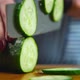 Women cuts a cucumber with a knife - VideoHive Item for Sale