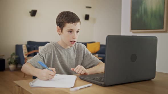 Young boy attending an online lesson during the COVID-19 lockdown