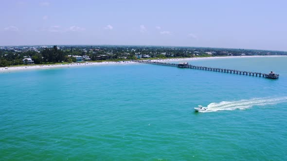 Aerial Drone View of Pier in the Ocean in Suny Day and Yachts Sail Around the Pier