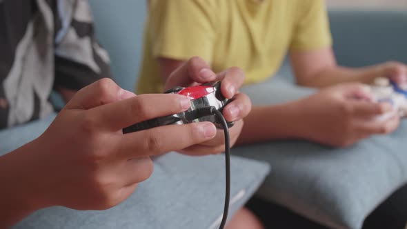 Close Up Children's Hands Holding Joystick Game Play Video Game At Home