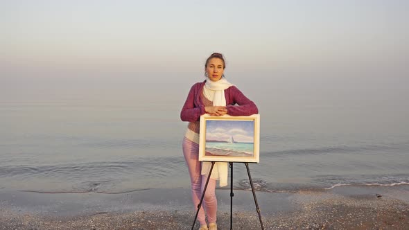 Elegant Woman Leaning on Easel with Amazing Seascape