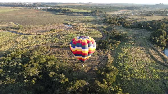 Colorful hot air balloon at rural scenery.