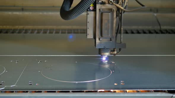 Laser cut machine while cutting the sheet metal with sparks and high precision
