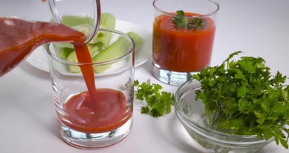 Pouring Organic Freshly Squeezed Tomato Juice Into a Glass