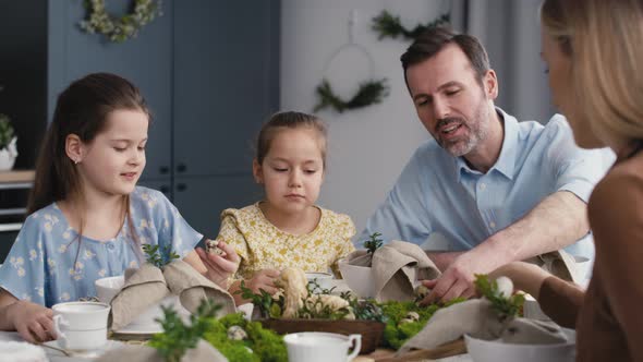 Caucasian family of five spending time over table on easter time. Shot with RED helium camera in 8K.