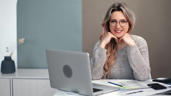 Cheerful Freelancer Woman Posing Table with Laptop and Paper