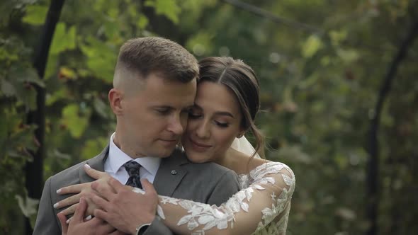 Lovely Newlyweds Caucasian Bride Embracing Groom in Park Making Kiss Wedding Couple Family Hugging