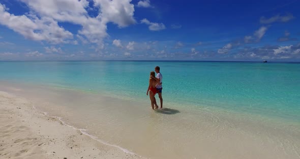 Young people after marriage in love live the dream on beach on sunny white sandy background 